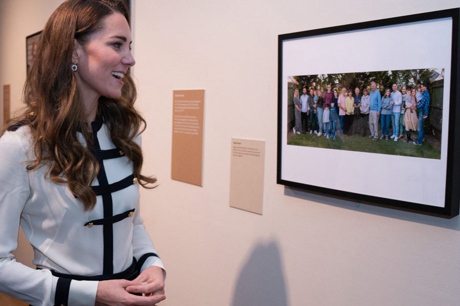 Britain's Catherine, Princess of Wales looks at a photograph of Ziggi Shipper and his family by photographer Arthur Edwards during a visit to the Imperial War Museum
