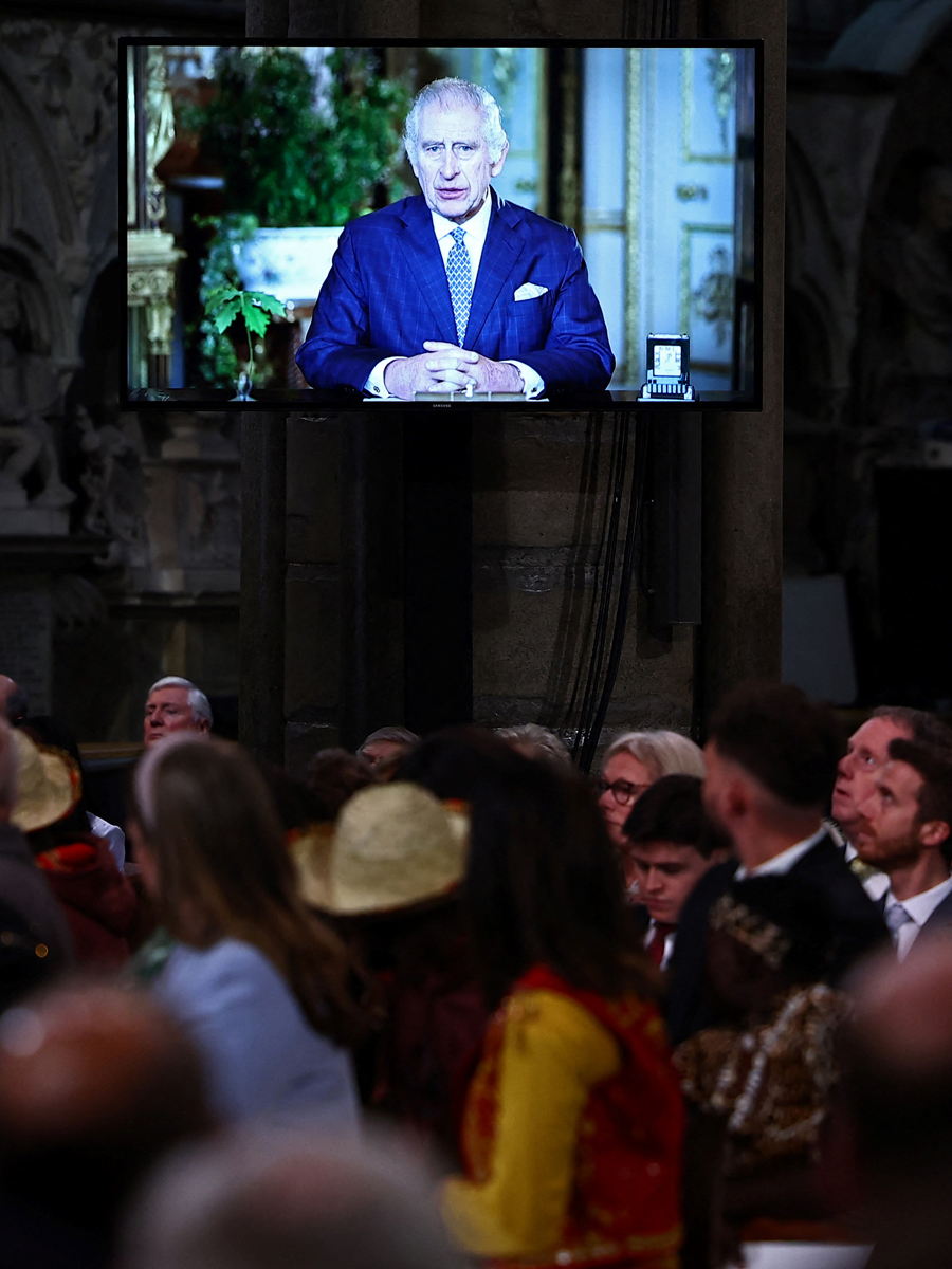 A video screen with King Charles III delivering a message during an annual Commonwealth Day service